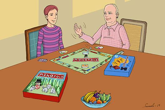Nuori mies ja iäkkäämpi mieshenkilö pelaavat Monopolya.