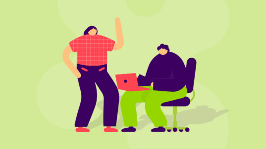 Kaksi hahmoa, joista toinen seisoo ja toinen on tietokoneella.