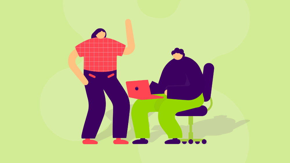 Kaksi hahmoa, joista toinen seisoo ja toinen on tietokoneella.