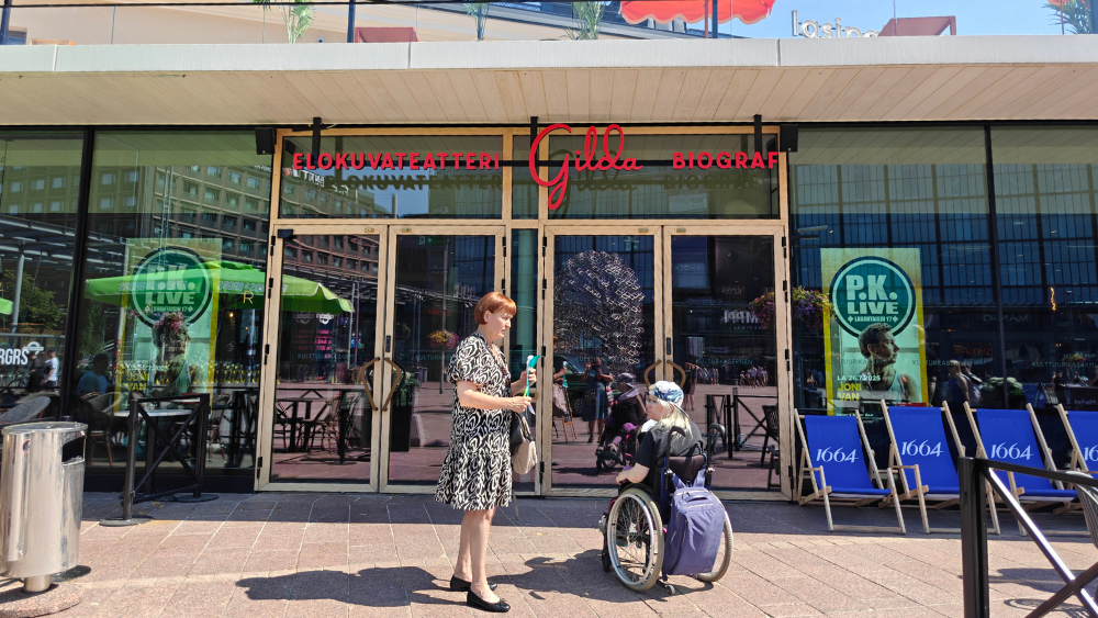 Aspan työntekijä ja kokemustoimija Gildan edessä.