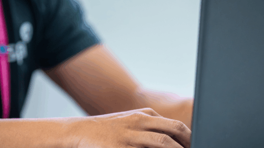 Kädet tietokoneella.